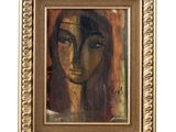 une peinture à l'huile représentant le visage d'une femme, dans un cadre doré