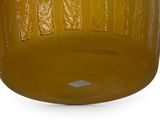 a glass jar with a yellow liquid inside of it