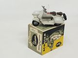 a toy motorcycle on top of a box on a white surface