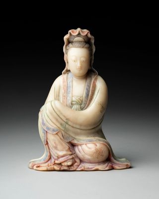an image of a statue of a woman sitting in a lotus position