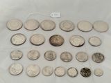 a close up of a bunch of coins on a white surface