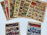 several old comic books are on a white surface