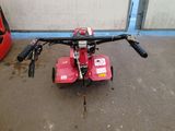 an image of a small red machine in a garage