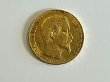 an image of a gold coin sitting on top of a white surface