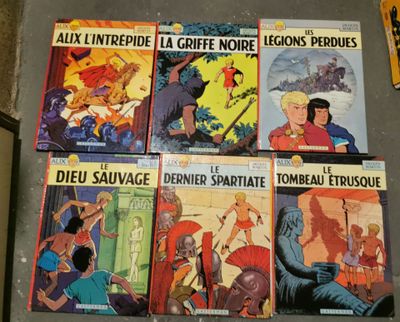 several comics are lined up on a table in a room