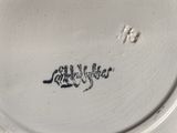 a white plate with a black writing on it