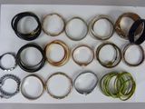 many different types of bracelets on a white tray