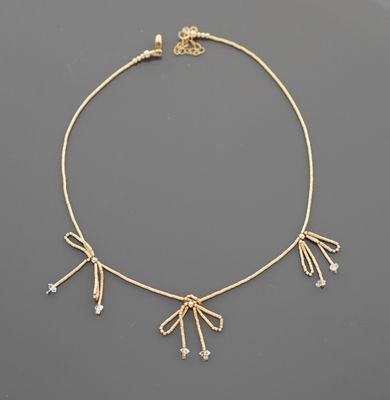 Collier en métal à perles doré dessinant des fleurs stylisée…