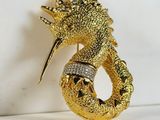 gold plated dragon brooch with crystal eyes