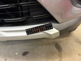 the front bumper of a car with a sticker on it ' s bumper