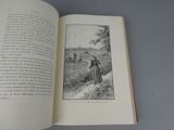an open book with a picture of a woman in a field