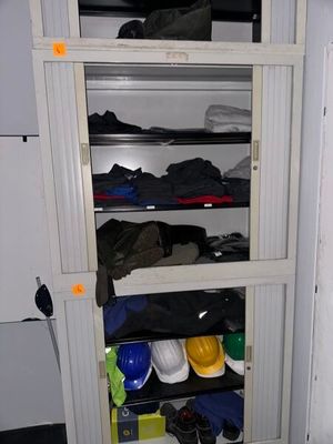 a tall cabinet with many pairs of shoes on it