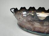 a large metal bowl with a handle on a table