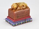 a figurine of a lion on a red base