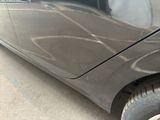 a close up of a car ' s front bumper with a denting on it