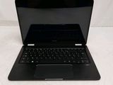 an open laptop computer sitting on top of a white surface