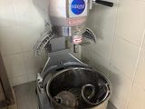 a mixer that is sitting on a stand in a kitchen