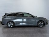 the grey car is parked in a large room with a white wall