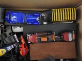 a cardboard box filled with toy cars and other toys