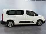 the white van is parked in the garage with its doors open