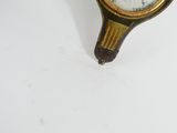 a gold and black clock on a white table