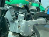 a tractor that is parked next to a motor scooter