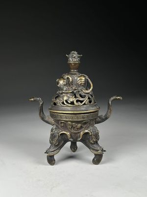 an old bronze incense box with a dragon on top