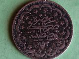 a coin that has a picture on it on a green surface