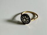 a gold ring with a black stone in it