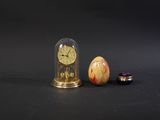 a glass dome with a clock inside of it on a table