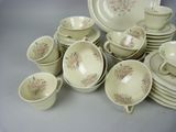 a lot of dishes and cups on the table