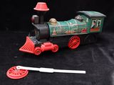 a toy train that is sitting on a black surface