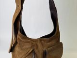 brown leather purse with zippers hanging from a hook on a wall