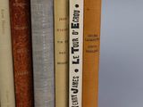 several books are stacked on top of each other on a table