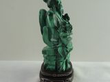 statue of a woman holding a baby in her arms on top of a table