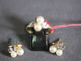 three pieces of jewelry sitting on top of a black box
