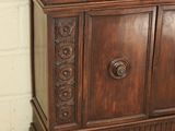 a wooden cabinet with a door on top of it