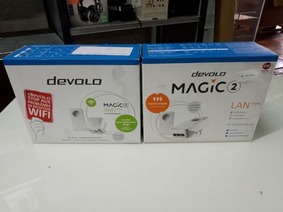 two boxes of devvolo magic 2 on a table in front of a tv