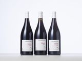 three bottles of wine sitting on top of a table next to each other