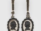 a pair of earrings with a portrait of a man and a woman