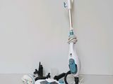 a white and blue steam mop sitting on a table