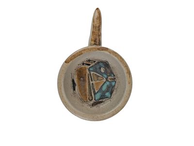 a picture of a ceramic object with a diamond on it