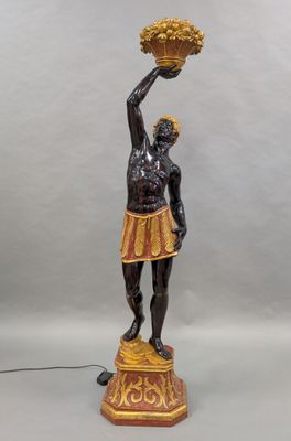 a statue of a woman holding a basket of flowers on a table