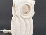 a white owl lamp with a cord attached to it