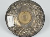 a silver plate with a flower design on it