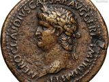 a bronze coin with a woman ' s head and a crown on it