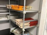 many shelves with baskets on them in a room
