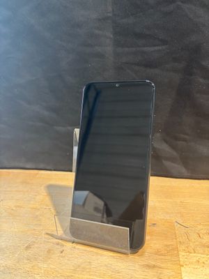 a cell phone that is sitting on a wooden table