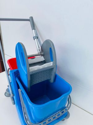 a blue bucket and a blue mop on a white table