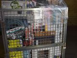 a metal cart with many items in it in a warehouse